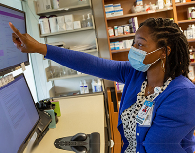 A pharmacist is using a computer