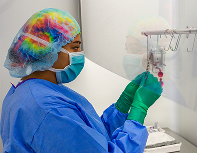 A pharmacist works in a sterile environment