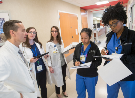 nurses and pharmacists standing in a hallway