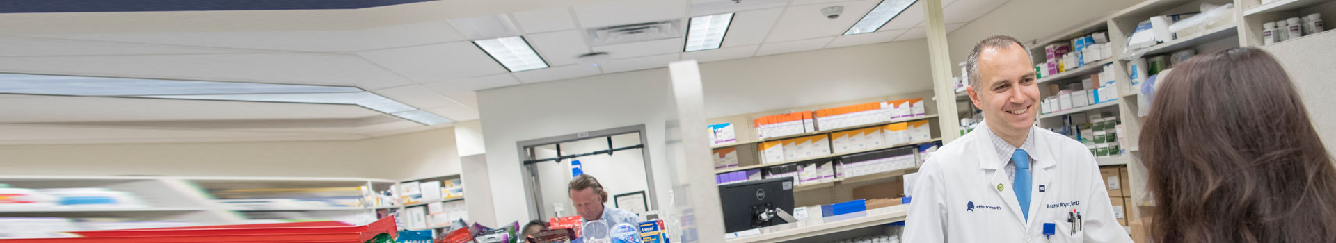 A make pharmacist speaks with a patient