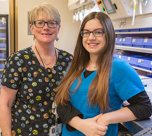 Two female pharmacy professionals in a pharmacy