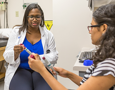A pharmacist consults with a patient about their medication