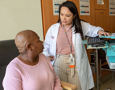 A female pharmacist speaks to a female patient