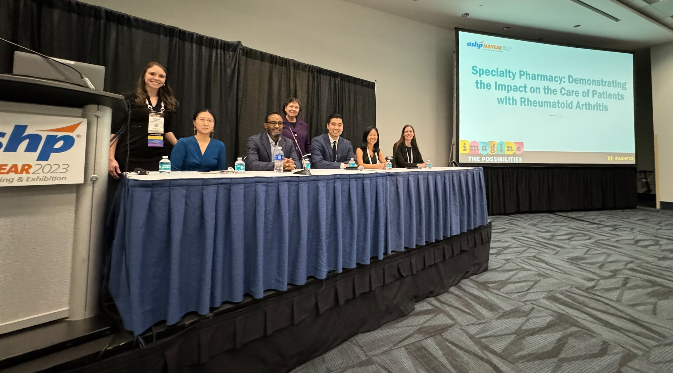 The five Specialty Pharmacy Care in Rheumatoid Arthritis Research Grant Recipients are at a table at the 2023 ASHP Midyear Meeting
